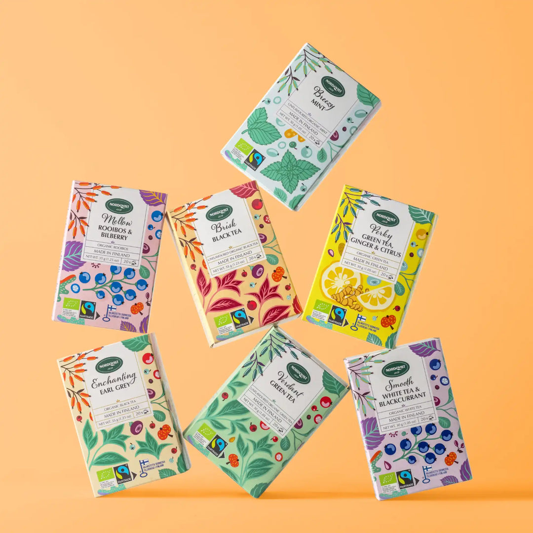 Blueberry tea box with colorful floral design and fair trade label.