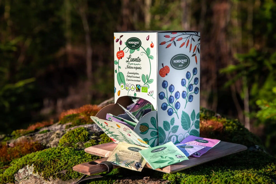 An open box of individually packaged herbal tea bags.