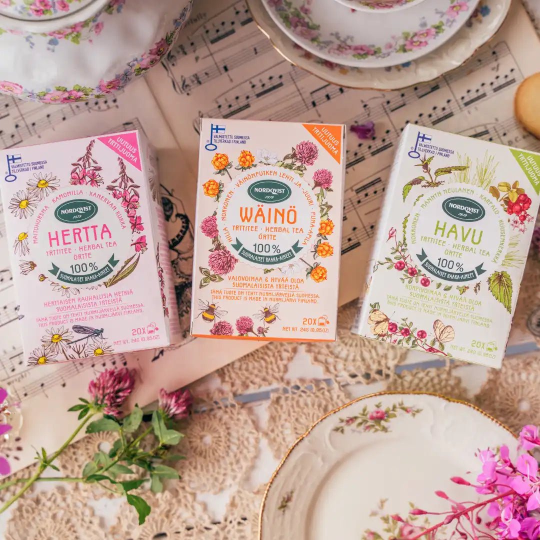 Three boxes of herbal tea with floral and bee illustrations.